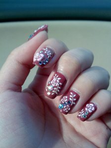 Red base with nail art stickers from Sasa and swarovski crystals